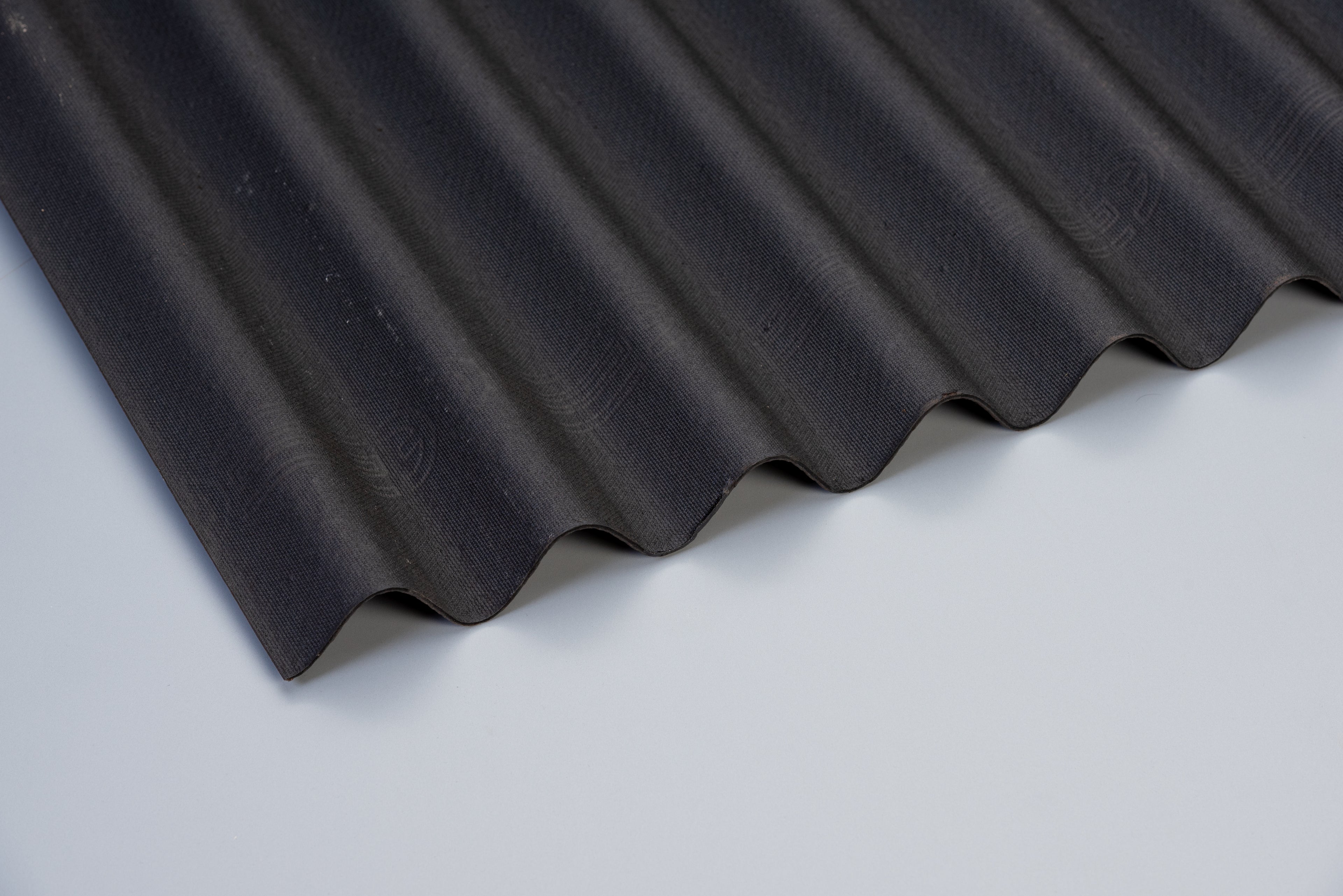 coroline bitumen roof sheet in black ona grey background
